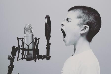 boy yelling into microphone